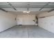 Clean, well-lit garage with storage cabinets, utility connections, and a door to the home's interior at 128 Arvind Oaks Cir, Cary, NC 27519