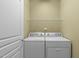 Practical laundry room with washer, dryer, and ample storage space at 128 Arvind Oaks Cir, Cary, NC 27519