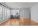 Spacious living room features hardwood flooring, large windows, and views into the sunroom at 128 Arvind Oaks Cir, Cary, NC 27519