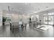 Large recreation room with multiple ping pong tables, great natural light, and a sleek modern flooring at 128 Arvind Oaks Cir, Cary, NC 27519