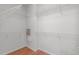 Spacious walk-in closet with white wire shelving and wood-look flooring for organized storage at 128 Arvind Oaks Cir, Cary, NC 27519