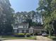Traditional two-story home featuring brick accents, a carport, and a well-manicured front lawn at 1305 Lennox Pl, Raleigh, NC 27612