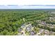 Neighborhood aerial with a pond and surrounding forest, showcasing a tranquil community setting at 1342 Briar Chapel Pkwy, Chapel Hill, NC 27516
