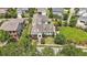 Gorgeous aerial view of a beautifully landscaped home, expansive lawn, and inviting outdoor patio area at 1342 Briar Chapel Pkwy, Chapel Hill, NC 27516