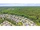 Aerial view of a residential neighborhood bordering a lush forest at 1342 Briar Chapel Pkwy, Chapel Hill, NC 27516