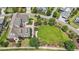 Stunning aerial view showcasing a luxurious home, lush landscaping, expansive lawn, and inviting outdoor living spaces at 1342 Briar Chapel Pkwy, Chapel Hill, NC 27516