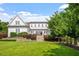 Beautifully landscaped backyard with a manicured lawn, elegant stone stairs, and inviting patio area, perfect for outdoor enjoyment at 1342 Briar Chapel Pkwy, Chapel Hill, NC 27516