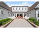 Elegant backyard patio with brick accents, lush landscaping, and comfortable seating, creating an ideal space for relaxation and entertainment at 1342 Briar Chapel Pkwy, Chapel Hill, NC 27516