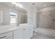 Bright bathroom with double vanity, white cabinets, an oversized mirror, and a shower-tub combination at 1342 Briar Chapel Pkwy, Chapel Hill, NC 27516