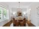 Bright dining area features a round table, stylish chairs, hardwood floors, and modern chandelier at 1342 Briar Chapel Pkwy, Chapel Hill, NC 27516