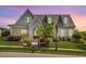 Beautiful craftsman-style home with stone accents, a well-manicured lawn, and mature trees showcasing curb appeal at 1342 Briar Chapel Pkwy, Chapel Hill, NC 27516