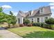 Charming traditional home boasting a lush green lawn, mature landscaping, and inviting curb appeal with detailed trim at 1342 Briar Chapel Pkwy, Chapel Hill, NC 27516