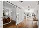 Bright foyer with wood floors, barn door, elegant chandelier, and seamless transition to other living spaces at 1342 Briar Chapel Pkwy, Chapel Hill, NC 27516