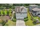 Aerial view of the home showcasing a two-car garage, driveway, and landscaped surroundings at 1342 Briar Chapel Pkwy, Chapel Hill, NC 27516