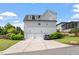 Two-car garage featuring a white brick facade and a driveway with parking space in a beautifully landscaped neighborhood at 1342 Briar Chapel Pkwy, Chapel Hill, NC 27516