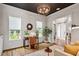 Light-filled office features a desk, chair, and decor under a dark-painted ceiling with modern lighting at 1342 Briar Chapel Pkwy, Chapel Hill, NC 27516