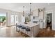 Bright kitchen featuring an island with seating and hardwood floors at 1342 Briar Chapel Pkwy, Chapel Hill, NC 27516