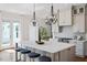 Stylish kitchen with island seating, pendant lighting, and stainless steel appliances at 1342 Briar Chapel Pkwy, Chapel Hill, NC 27516