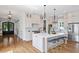 Well-lit kitchen with island, pendant lights, and stainless appliances at 1342 Briar Chapel Pkwy, Chapel Hill, NC 27516