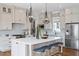 Gourmet kitchen with oversized island, stainless steel appliances, and designer lighting at 1342 Briar Chapel Pkwy, Chapel Hill, NC 27516