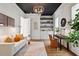 Stylish living room features a sofa, modern light fixture, hardwood floors and large windows at 1342 Briar Chapel Pkwy, Chapel Hill, NC 27516