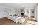 Spacious living room with hardwood floors, a fireplace, custom built-ins, and large windows with a lot of natural light at 1342 Briar Chapel Pkwy, Chapel Hill, NC 27516