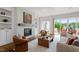 Cozy living room featuring a fireplace, built-in shelves, and access to a patio at 1342 Briar Chapel Pkwy, Chapel Hill, NC 27516
