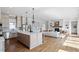 Open-concept kitchen and living room with fireplace and modern finishes at 1342 Briar Chapel Pkwy, Chapel Hill, NC 27516