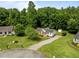 Aerial view of the property featuring a long driveway and mature trees at 1383 Deercroft Ct, Graham, NC 27253