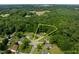 Aerial view outlining property lines nestled in a wooded neighborhood at 1383 Deercroft Ct, Graham, NC 27253