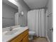 Well-lit bathroom featuring a shower with curtain, vanity, and neutral wall color at 1383 Deercroft Ct, Graham, NC 27253