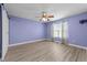 Bedroom featuring ceiling fan, barn door, and laminate flooring at 1383 Deercroft Ct, Graham, NC 27253