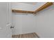Walk-in closet with simple shelving and laminate flooring at 1383 Deercroft Ct, Graham, NC 27253