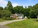 Ranch-style home on a large lot with a long driveway and mature trees at 1383 Deercroft Ct, Graham, NC 27253