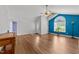 View of the light-filled living room with wood floors and vaulted ceilings at 1383 Deercroft Ct, Graham, NC 27253