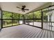 Screened-in porch with ceiling fan overlooks the outdoor deck at 1383 Deercroft Ct, Graham, NC 27253