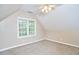 Well-lit bedroom with ceiling fan and angled ceiling at 142 College Ave Ave, Durham, NC 27713