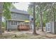 Exterior view of the home and the backyard, featuring a deck and a storage shed at 142 College Ave Ave, Durham, NC 27713