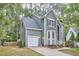 Lovely two-story home with gray siding, manicured lawn, attached garage, and a welcoming front entrance at 142 College Ave Ave, Durham, NC 27713