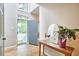 Bright and open foyer featuring a stylish console table, mirror, and an inviting view of the home's interior at 142 College Ave Ave, Durham, NC 27713