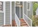 Charming entryway with a stylish front door, white railings, and brick steps leading to a welcoming home at 142 College Ave Ave, Durham, NC 27713