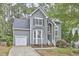 Charming two-story home with a well-maintained lawn, attached garage, and classic architectural details at 142 College Ave Ave, Durham, NC 27713