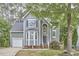 Beautiful two-story home with a well-manicured lawn, gray siding, and mature trees in a tranquil setting at 142 College Ave Ave, Durham, NC 27713