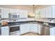 Modern kitchen featuring white cabinets, stainless steel appliances, and hardwood floors at 142 College Ave Ave, Durham, NC 27713
