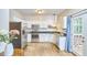Well-lit kitchen with stainless steel appliances, white cabinets, and access to a deck at 142 College Ave Ave, Durham, NC 27713