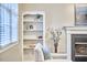 Living room featuring built-in shelving, fireplace, and large windows with natural light at 142 College Ave Ave, Durham, NC 27713