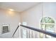 Well-lit staircase featuring a dark banister, white spindles, and a large arched window at 142 College Ave Ave, Durham, NC 27713