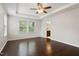 Bright bedroom featuring a ceiling fan, hardwood flooring, and attached bathroom at 143 Thornbury St, Clayton, NC 27527