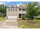 Inviting two-story home features a well-kept lawn, attached garage, and welcoming covered porch at 143 Thornbury St, Clayton, NC 27527