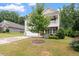 Well-maintained home features an attached garage, landscaping, and a beautiful shade tree at 143 Thornbury St, Clayton, NC 27527
